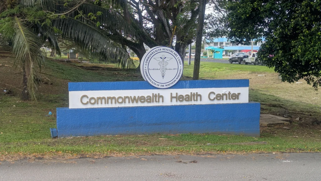 Commonwealth Health Center sign with caduceus seal at the entrance of the hospital in Saipan, CNMI.